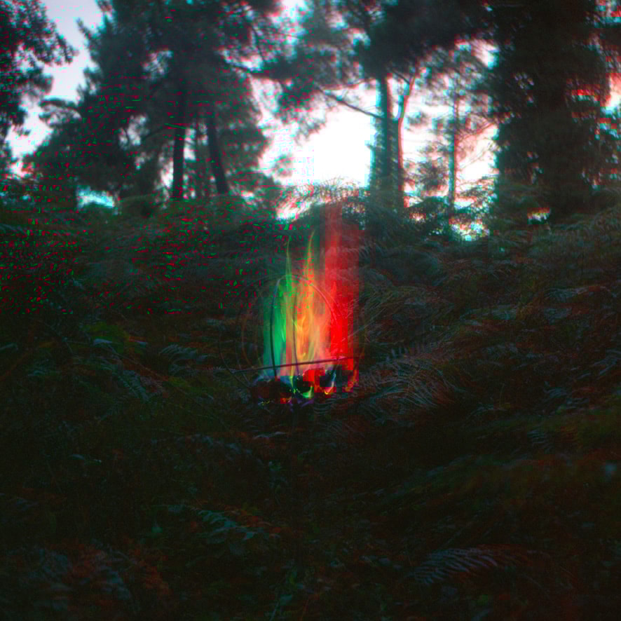 Two women sitting at a modern table talking with a city view behind them.